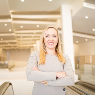 Woman at the top of an escalator