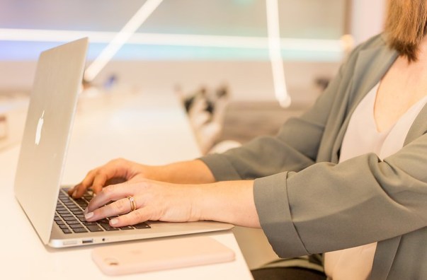 Woman typing on a computer.