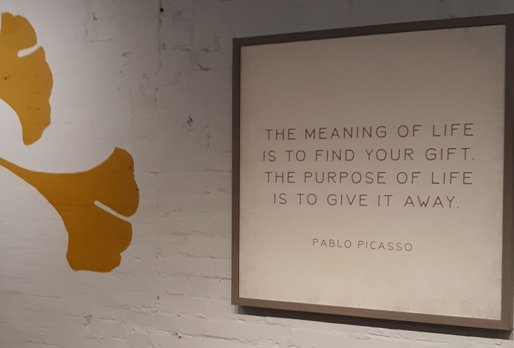 Sign on the wall that reads "The meaning of life is to find your gift. The purpose of life is to give it away."
