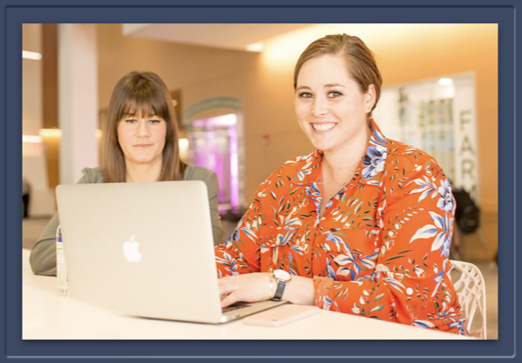 Two women happily working together