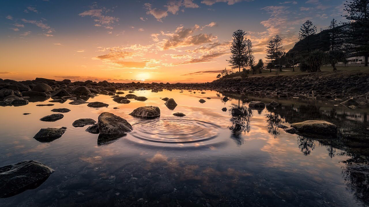 Water rippling on a pond at sunset.