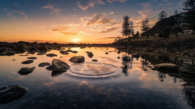 Water rippling on a pond at sunset.