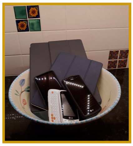 Bowl full of iPads and cell phones