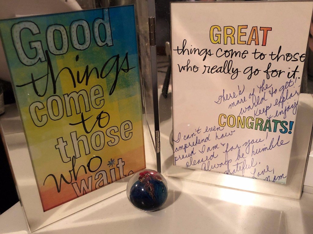 Picture of a framed card that says, "Good things come to those who wait. Great things come to those who really go for it." #gogettheworld #encouragement
