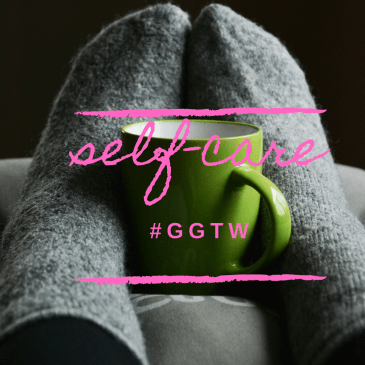 Feet in woolen socks hugging a tea cup.