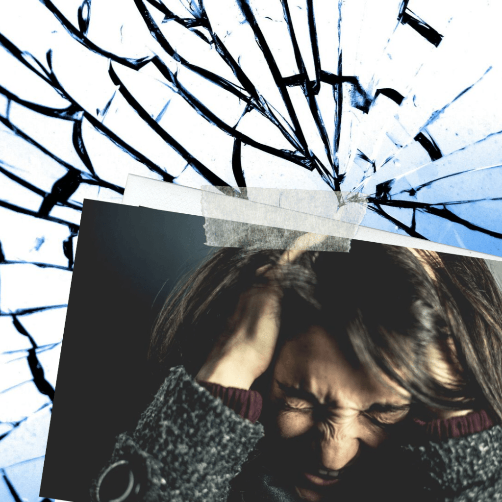 Broken mirror above an exasperated woman