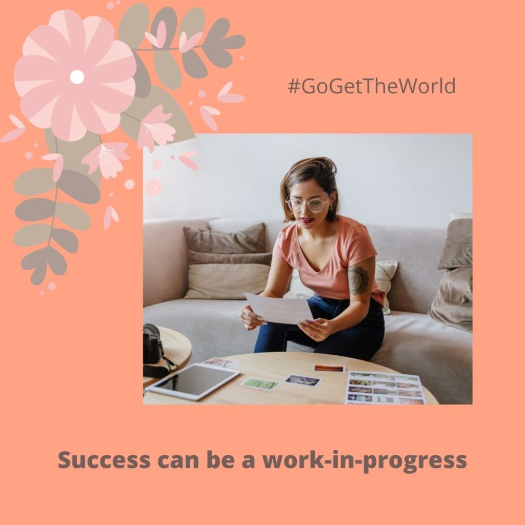 Woman looking over various images at a table.